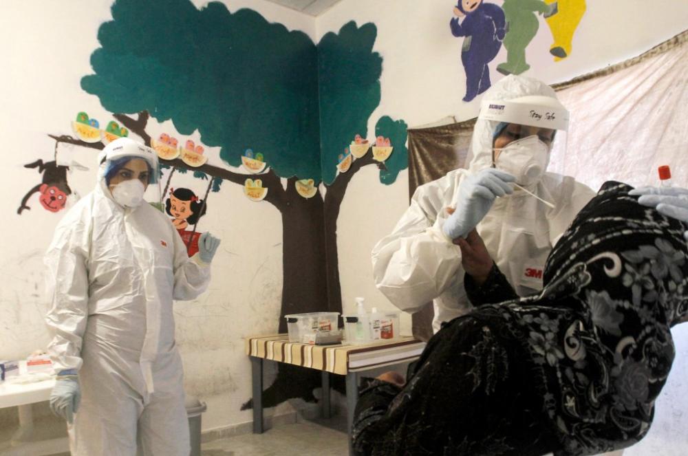 A Syrian refugee gets checked for the covid-19 caused by the novel coronavirus, during a testing campagne organised by Lebanon's health ministry and the United Nations High Commissioner for Refugees (UNHCR) in the southern city of Sidon, on May 28, 2020. By Mahmoud ZAYYAT / AFP.