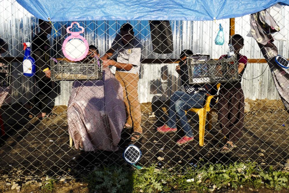This impromptu barber set-up was pictured by Peter van Agtmael at the Al-Khazer IDP camp, in Iraq, in 2017
